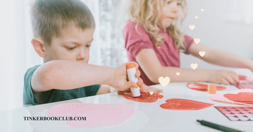 Two young children creating Valentines with paper hearts, glue, and stickers. Non-Candy Valentine's Day Ideas.