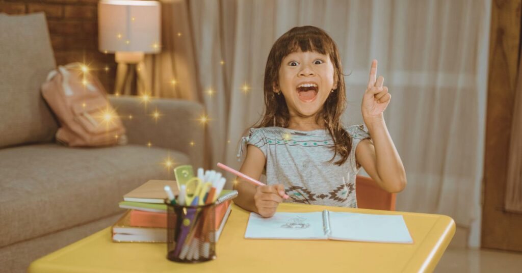 A girl sits at a table writing in a notebook. She is smiling and happy. Fairy tale unit study vs. book club.